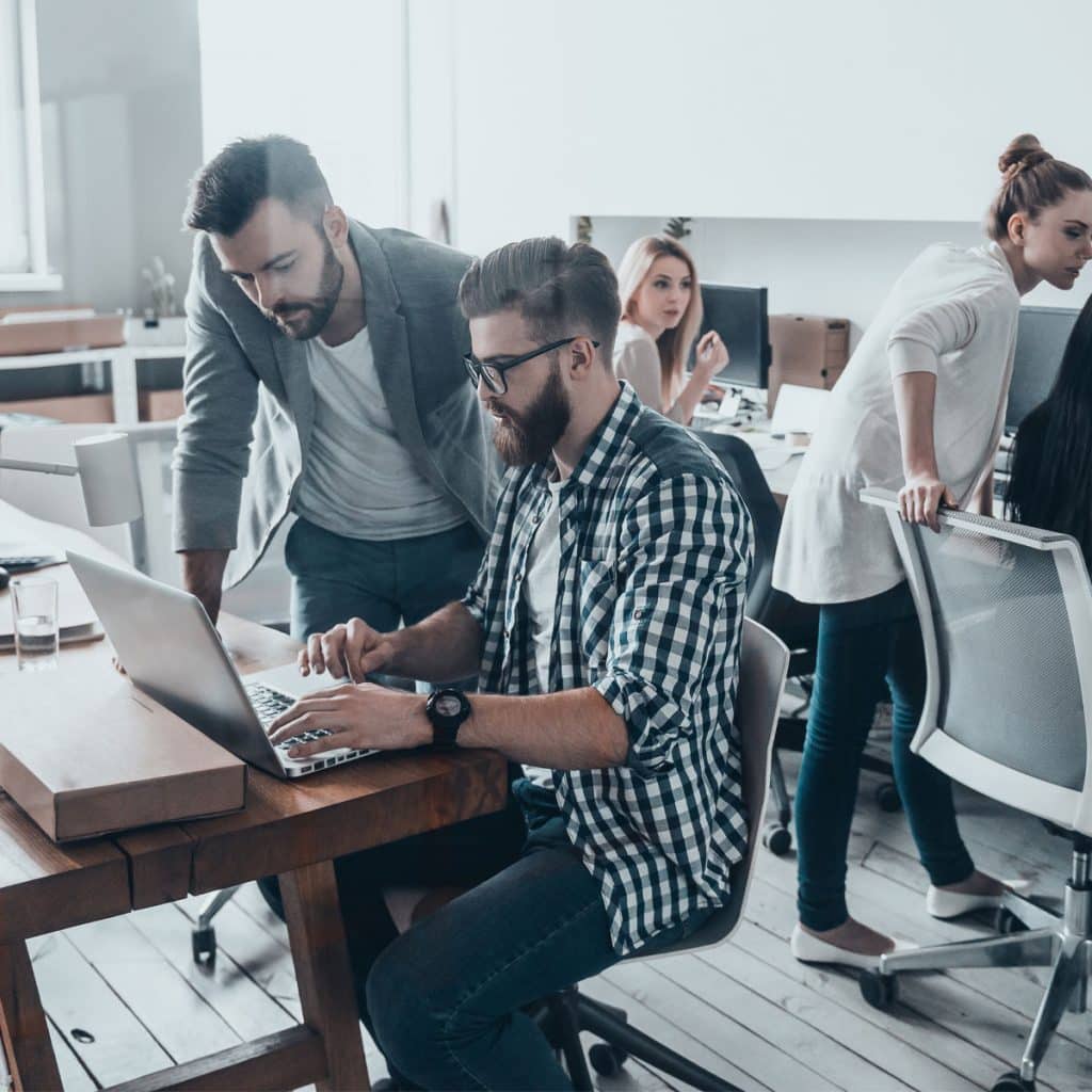 a group of people working on a laptop